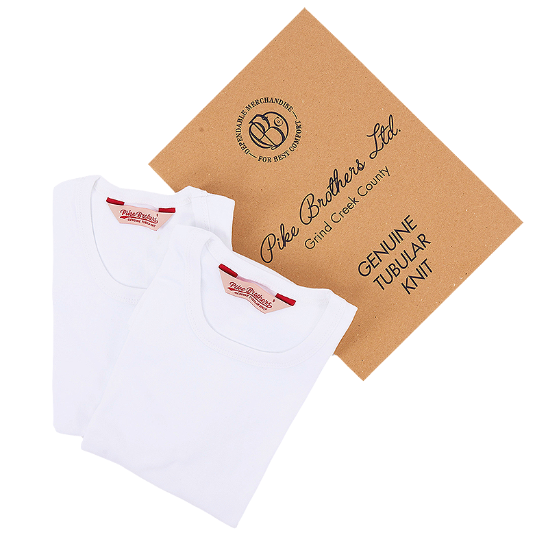 Two white t-shirts and a brown cardboard box labeled 'Pike Brothers Ltd.'