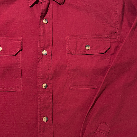 Close-up of a red shirt with button details