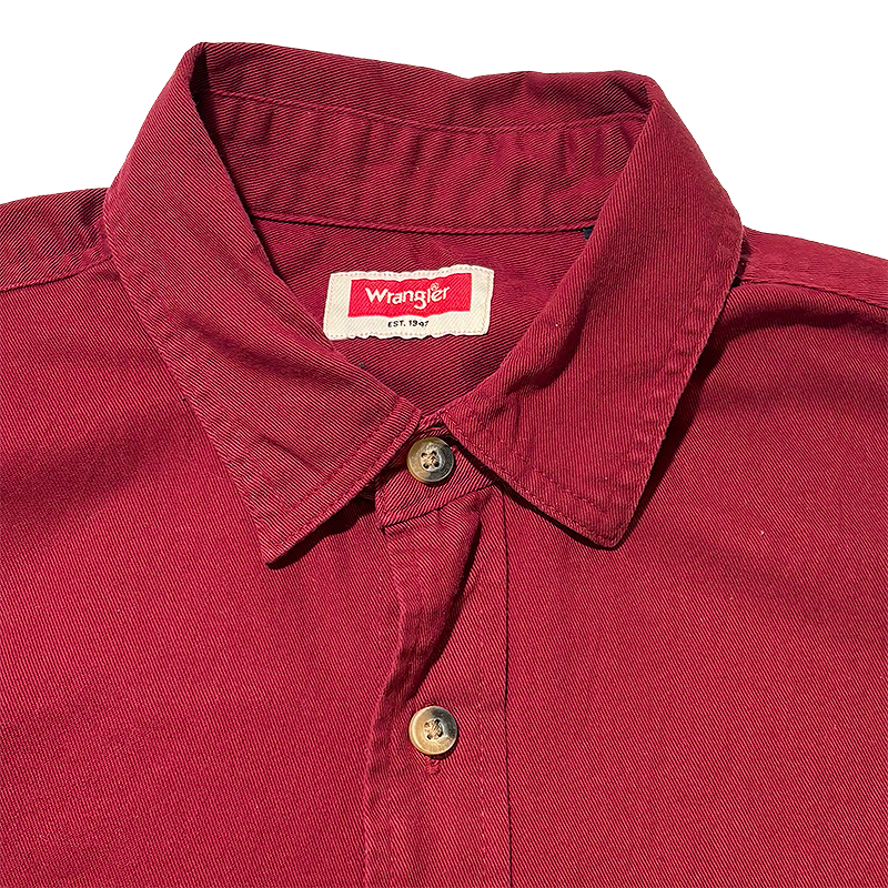 Close-up of a red shirt with a Wrangler label