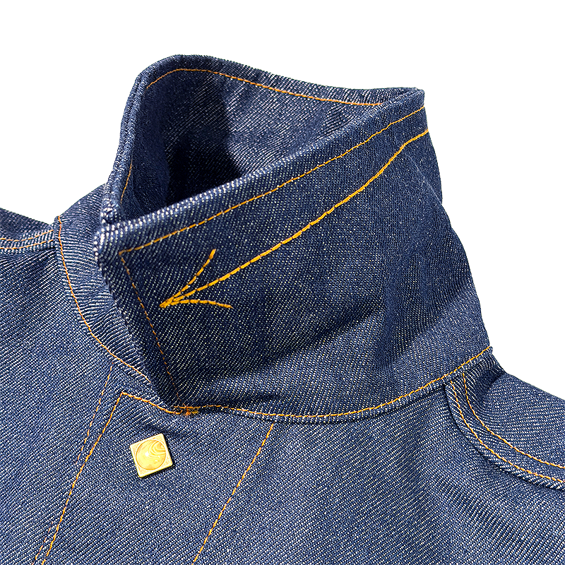 Close-up of blue denim fabric with yellow stitching