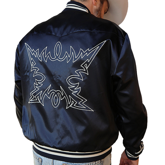 Person wearing a navy blue H Bar C Jacket with white graphics on the back