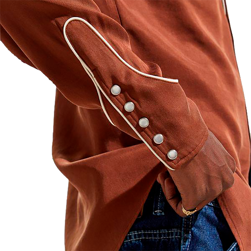 Close-up of a brown western shirt with white trim and pearl snaps