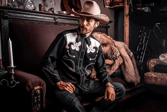 Man with a 1970s western shirt with embroidery and rhinestones.