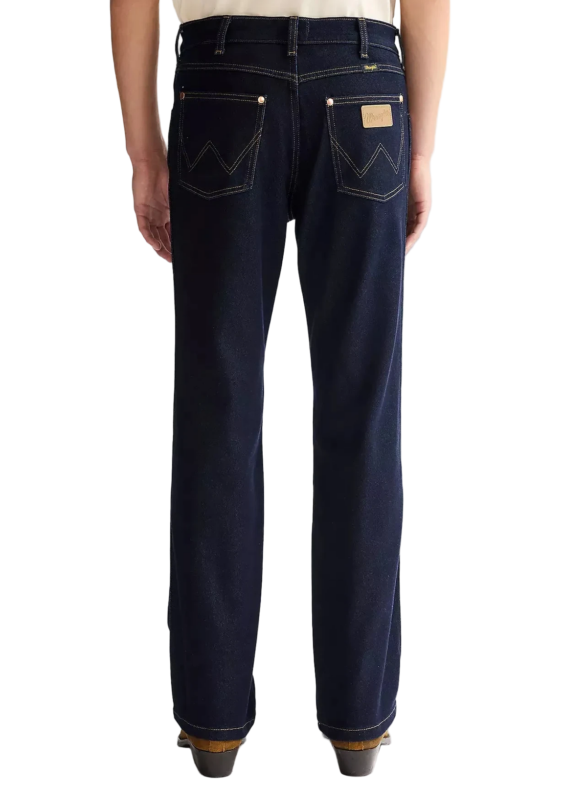 Person wearing dark blue Wrangler jeans