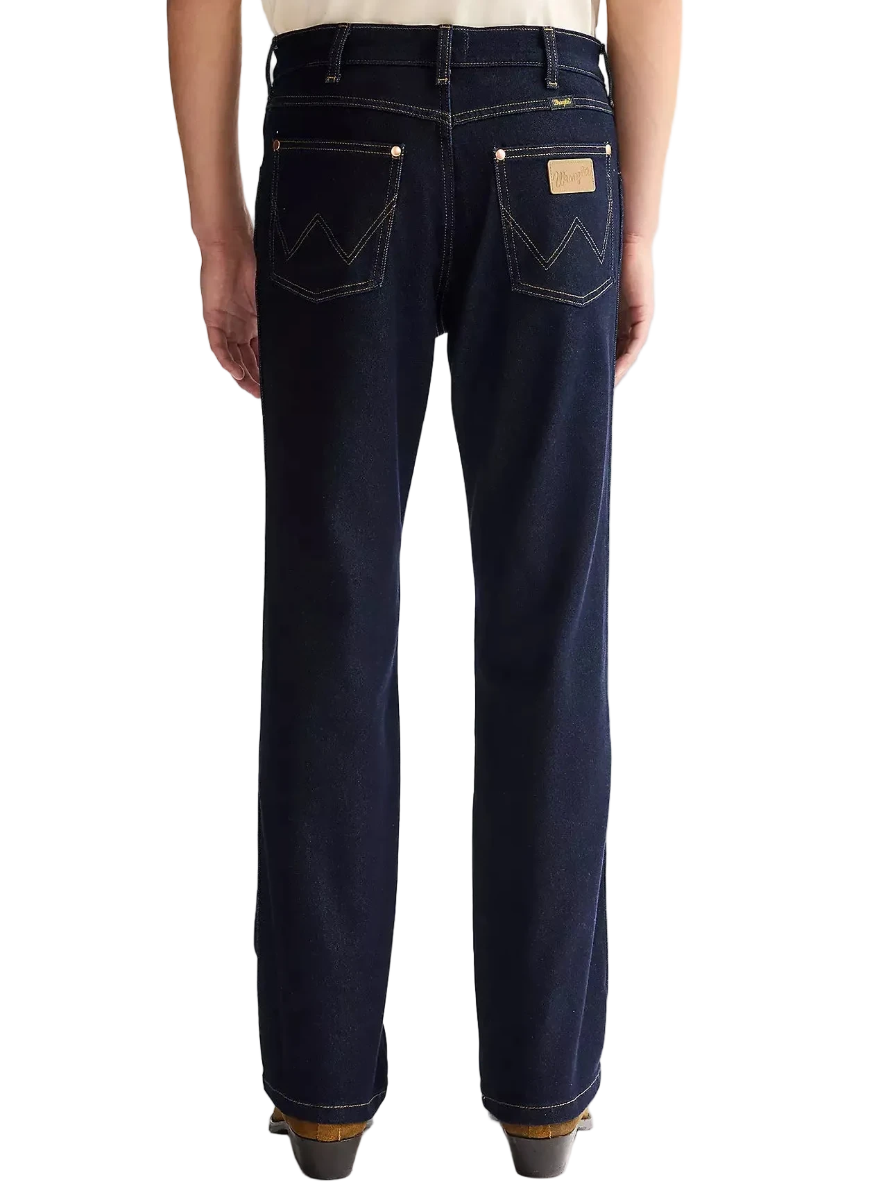 Person wearing dark blue Wrangler jeans