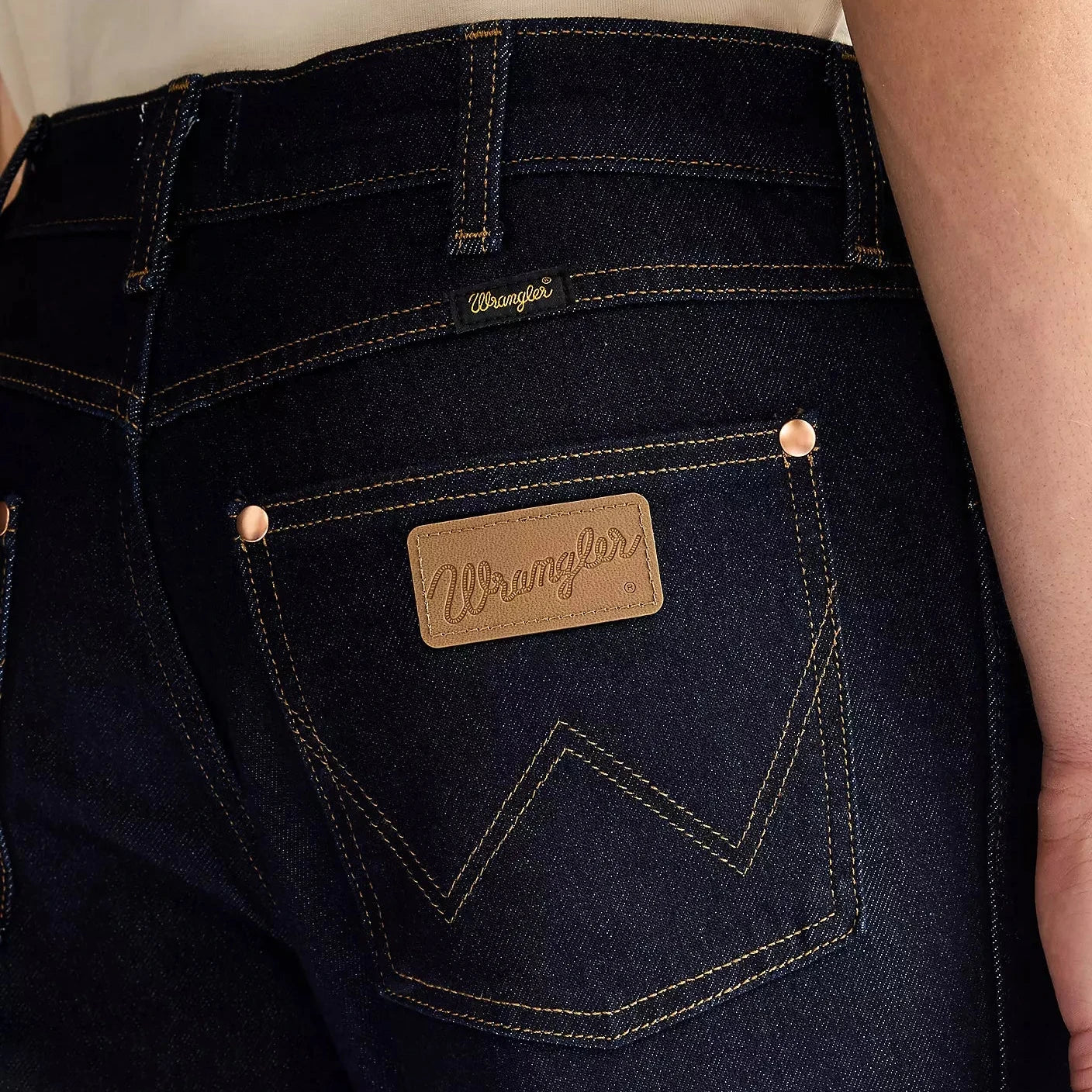 Dark blue jeans with Wrangler logo on pocket and label