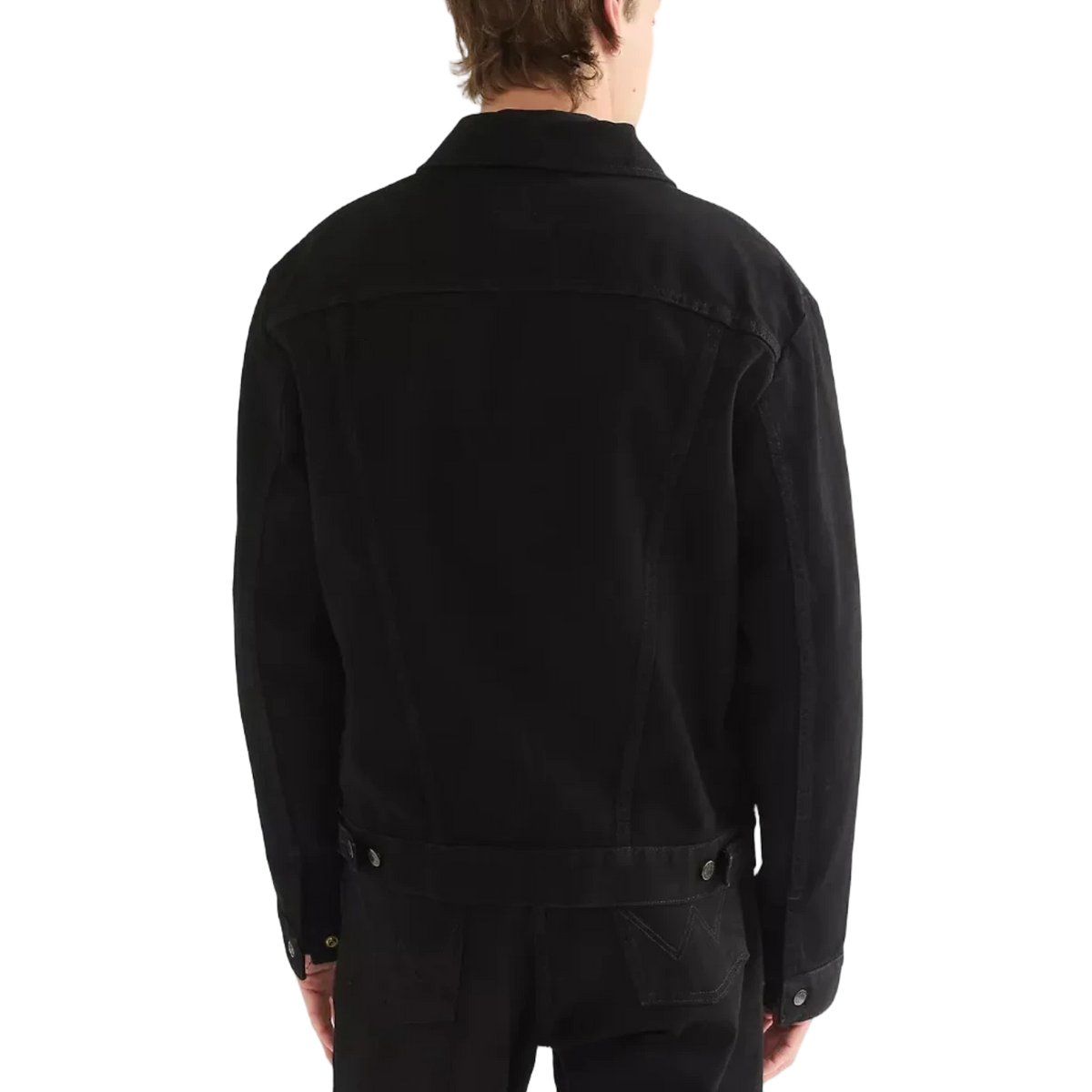 A man viewed from the back wearing a black Wrangler Cowboy Cut denim jacket and black jeans.