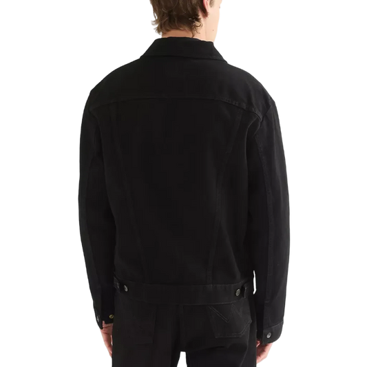 A man viewed from the back wearing a black Wrangler Cowboy Cut denim jacket and black jeans.