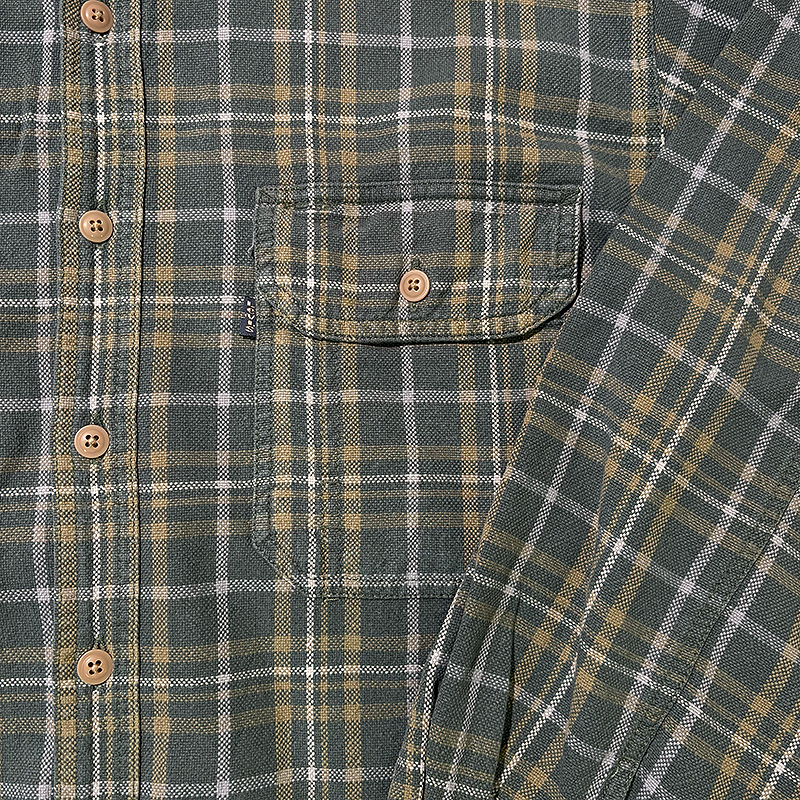 Close-up of a plaid shirt with buttons and a pocket and the Levi's black tab
