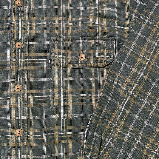 Close-up of a plaid shirt with buttons and a pocket and the Levi's black tab