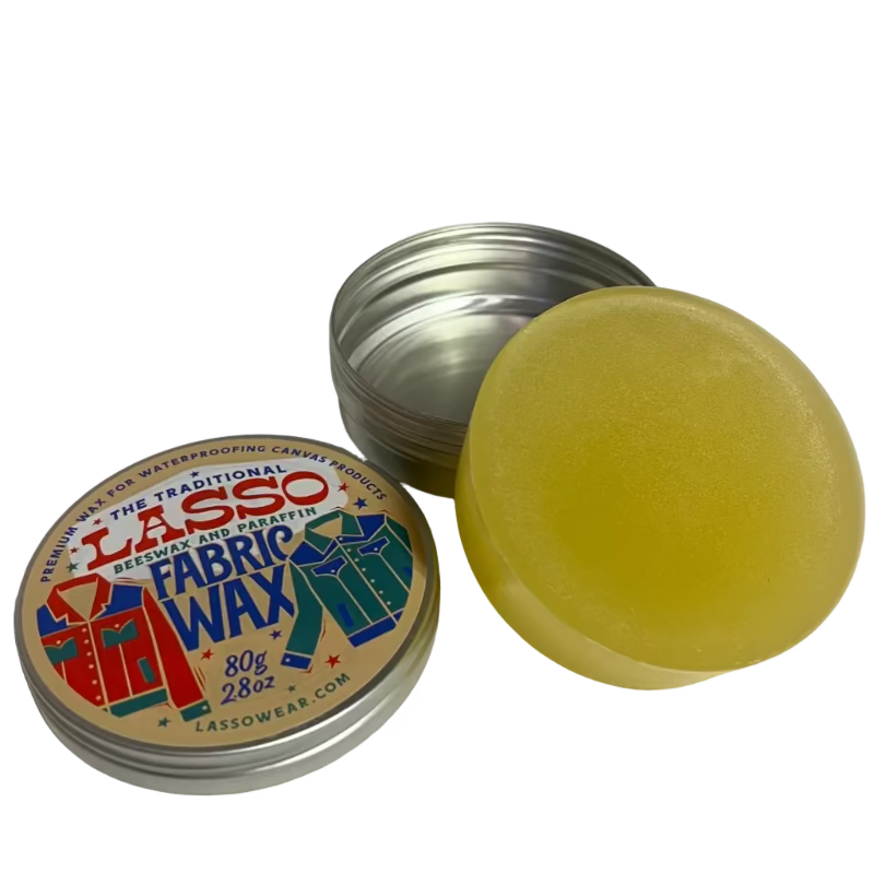 Lasso Fabric Wax round tin opened and the wax is out of the tin. 