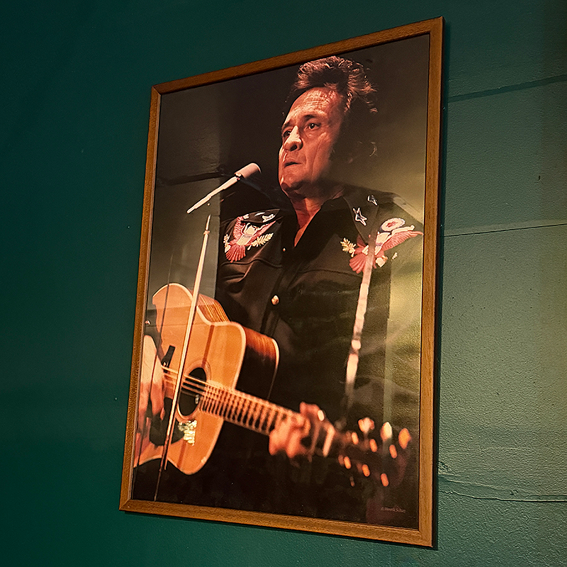 Framed picture of Johnny Cash playing guitar