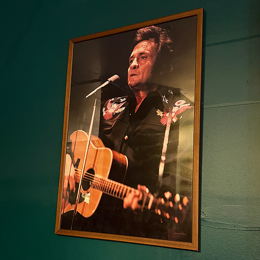 Framed picture of Johnny Cash playing guitar