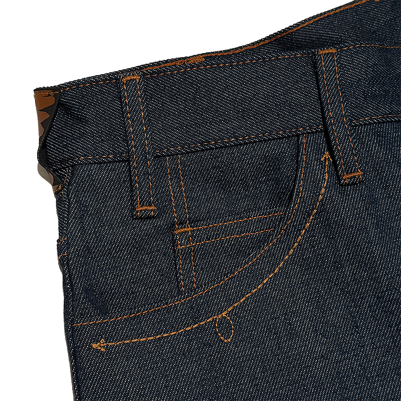 Close-up of dark blue denim jeans with brown stitching