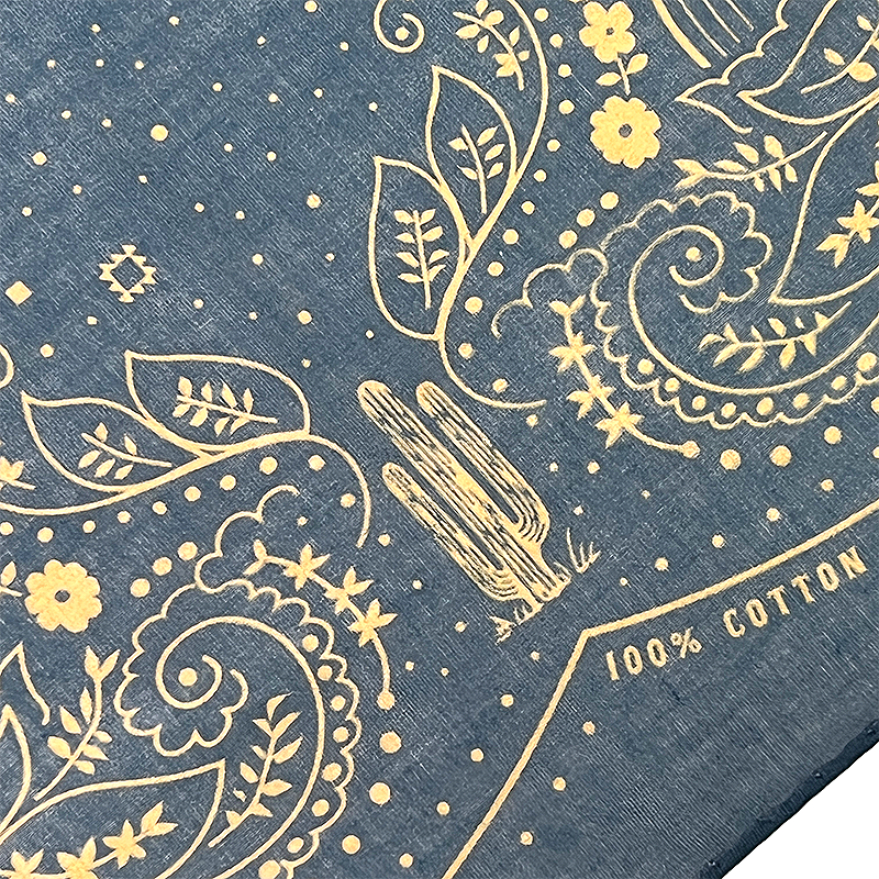 Bandana with paisley patterns and '100% Cotton' text