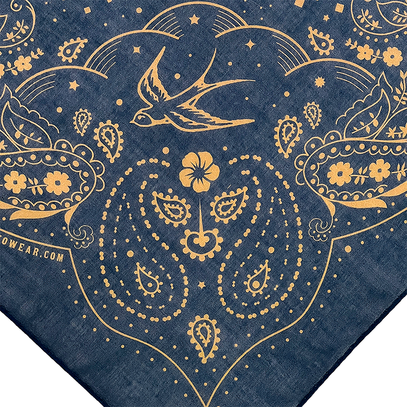 Bandana with gold paisley patterns, flowers, and a swallow on blue background.