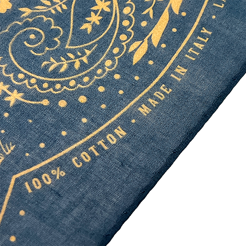Detail on a bandana with texts "100% cotton" and "Made in Italy".