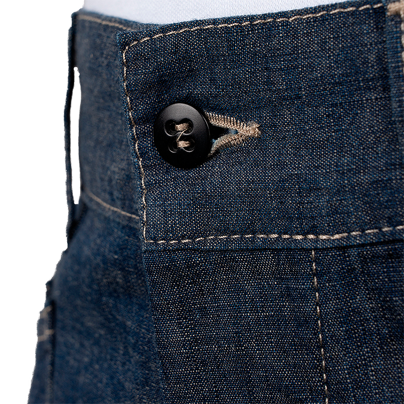 Close-up of a button on a pair of blue jeans