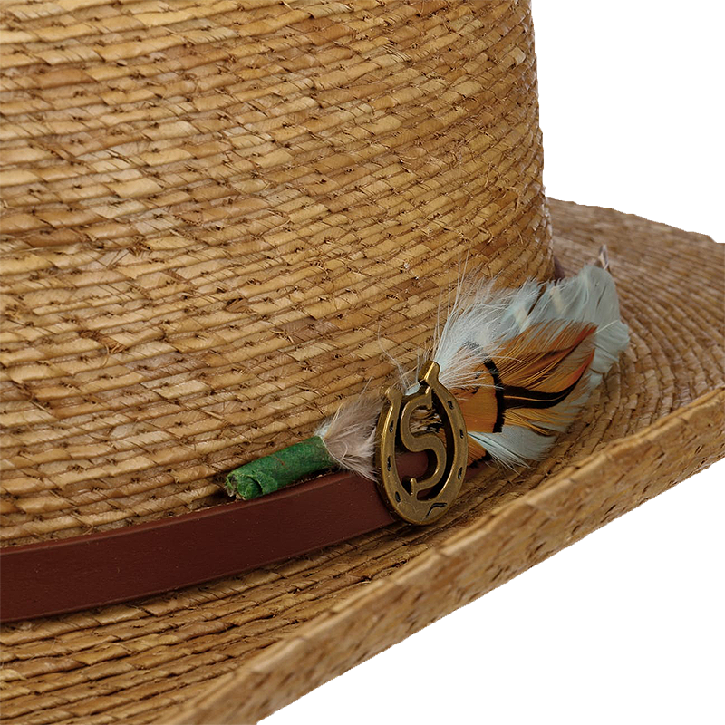 Close-up of a straw hat with decorative feather and brown band