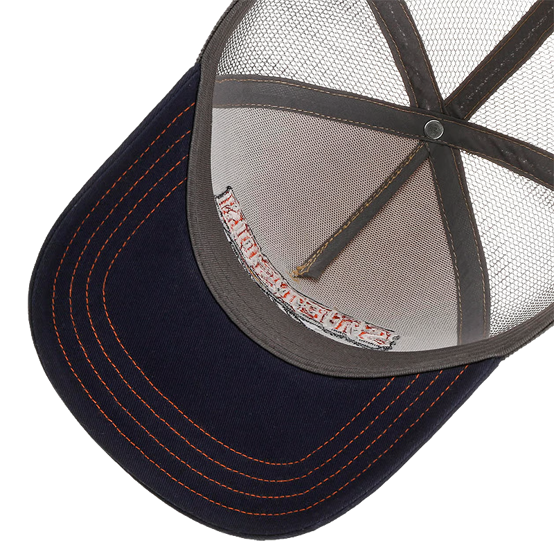 Close-up of a trucker-style baseball cap with a dark navy blue visor, orange contrast stitching, and a gray mesh back.