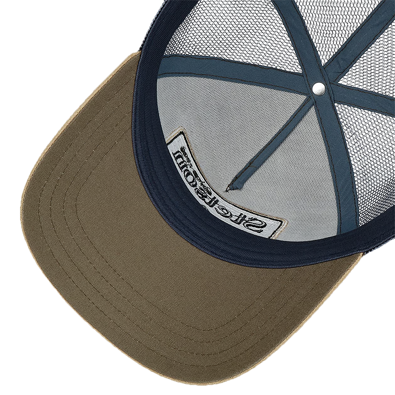 Close-up of the back of a trucker-style cap showing an olive green brim, navy blue mesh back, and a white interior label with black text.