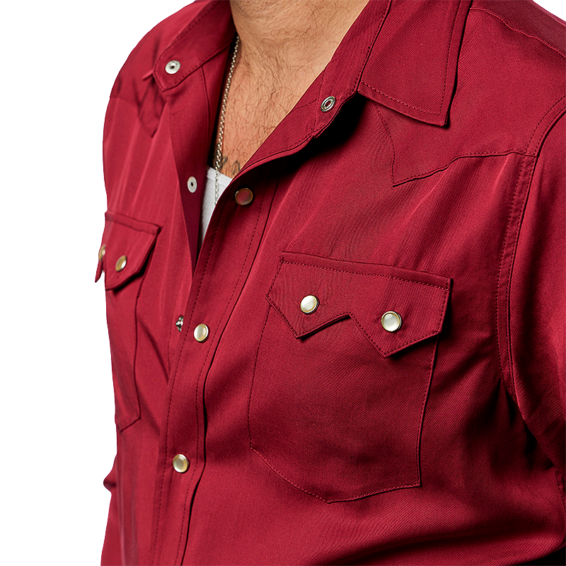 Close-up of a red western shirt with white pearl snaps