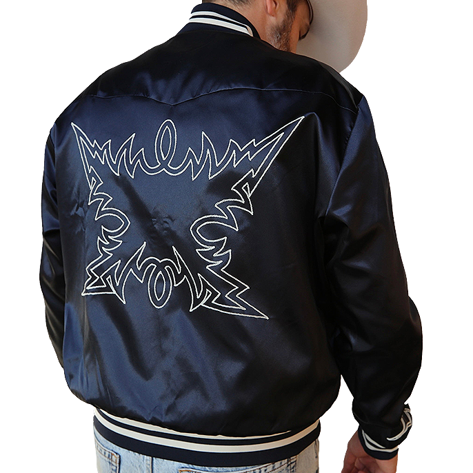 Person wearing a navy blue H Bar C Jacket with white graphics on the back